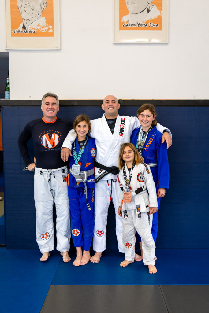 Family Jiu Jitsu portrait with students and instructor