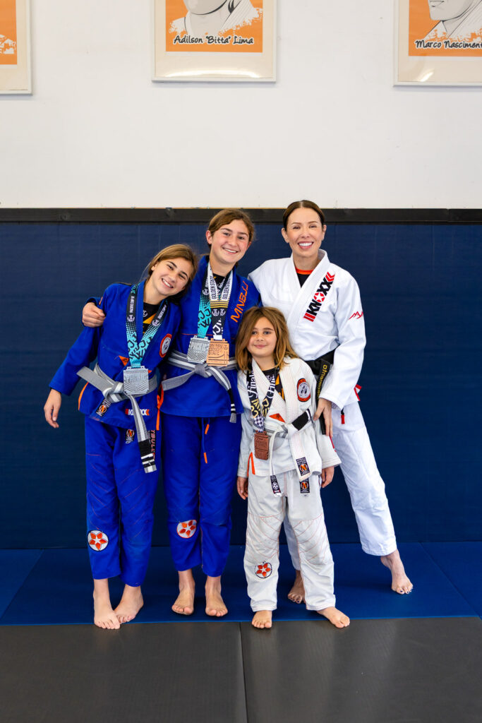 Coach Christina celebrating with young medalists at Marco Nascimento martial arts school
 on the San Francisco Peninsula