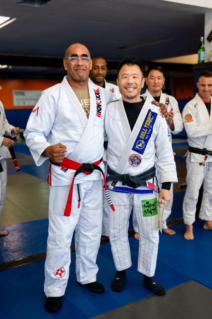 Students learning BJJ techniques
celebrating with promoted student