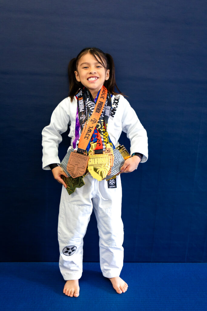 Young Jiu Jitsu students posing together at a Bay Area San Mateo kids class