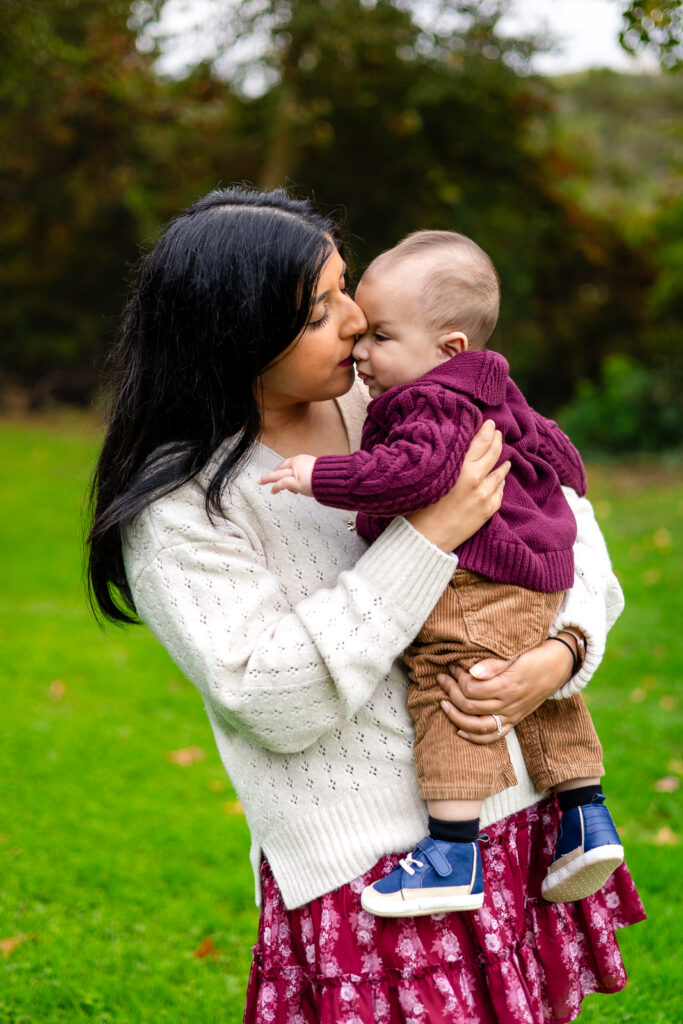 Mom holding her baby during a sweet moment at Millbrae outdoor photo location in San Mateo County Bay Area