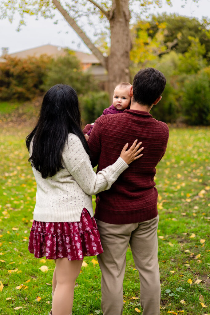 Parents walking with their baby at Meadows Park Millbrae in San Mateo County