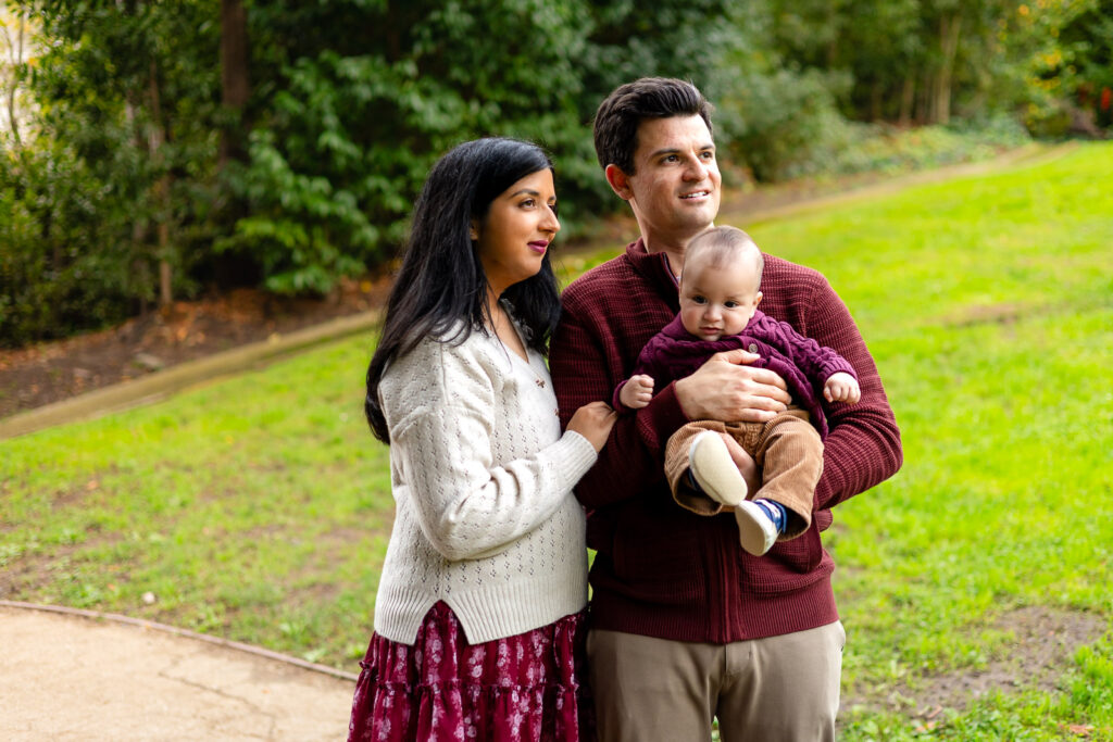 Parents looking out while holding their baby at Millbrae community park in San Mateo County