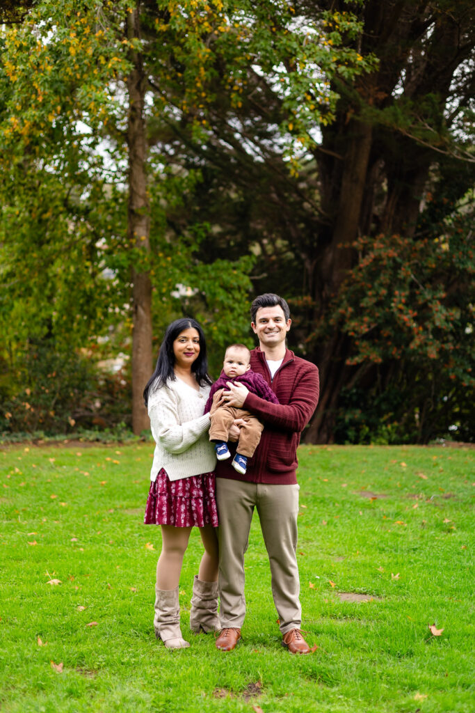 Family standing together in the open field at sunset portraits in the wide open fields of Meadows Park