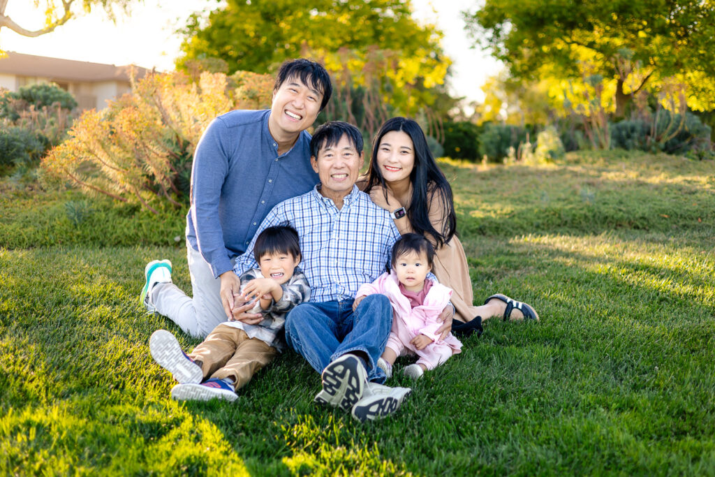 Bay Area multigenerational family laughing together on the grass during a mini session
