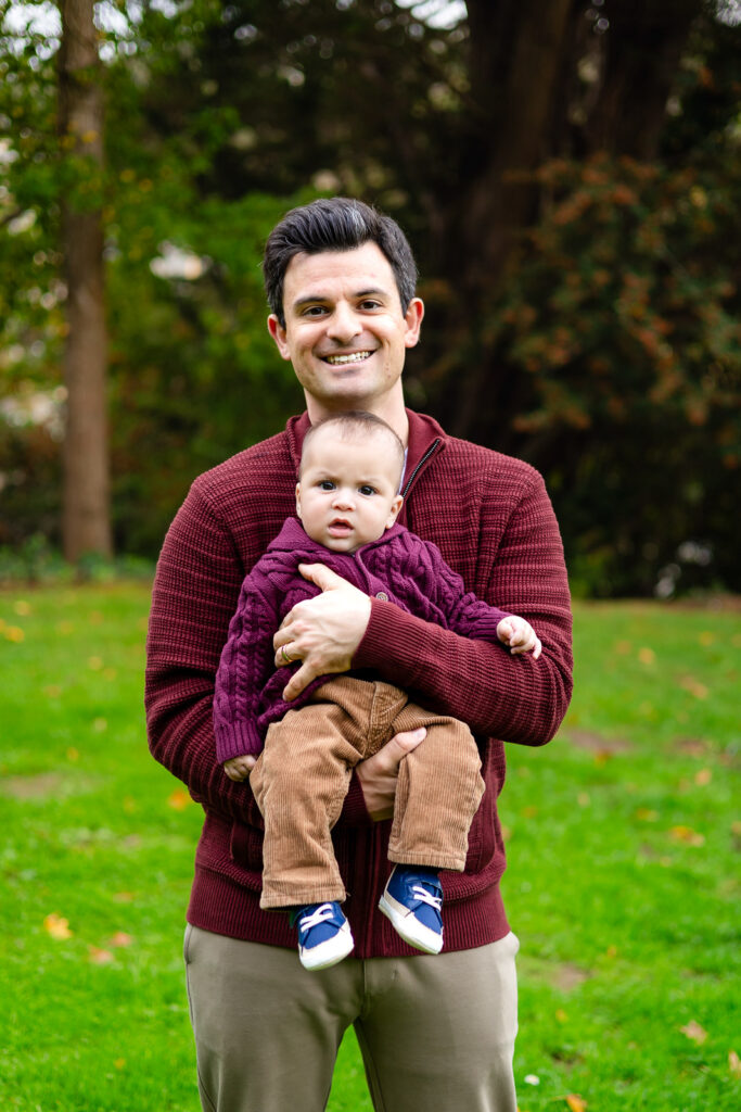Father holding his baby during a San Mateo Parents Club session at a San Carlos park