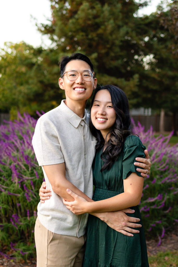 Parents hugging in a garden at sunset family photos with kids