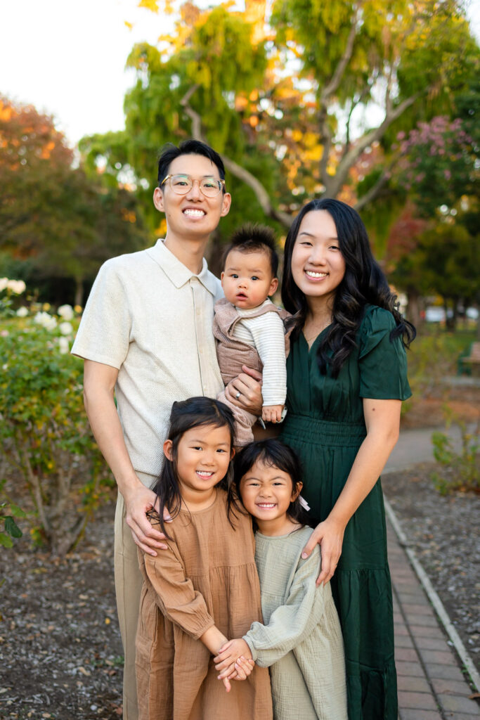 Bay Area family smiling together during golden hour for tips for family photos with toddlers