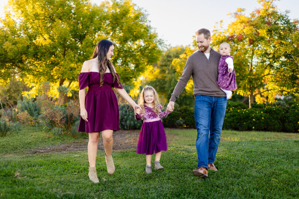 Family walking on the grass at Leo Ryan Park in Foster City for a essentials to bring for outdoor photos guide