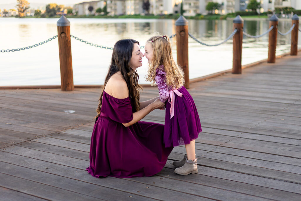 Mom kneeling with her daughter on the Foster City boardwalk during a a quick checklist for photo day article