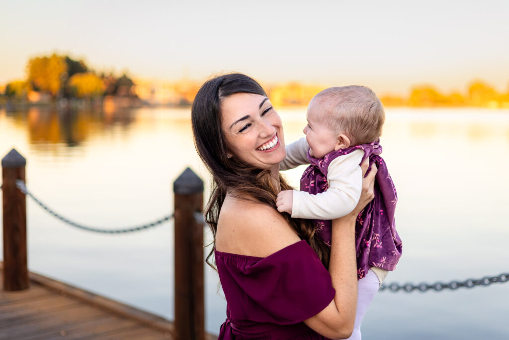 Mom holding baby near the boardwalk at Foster City Lagoon for a a simple checklist for photo day
guide