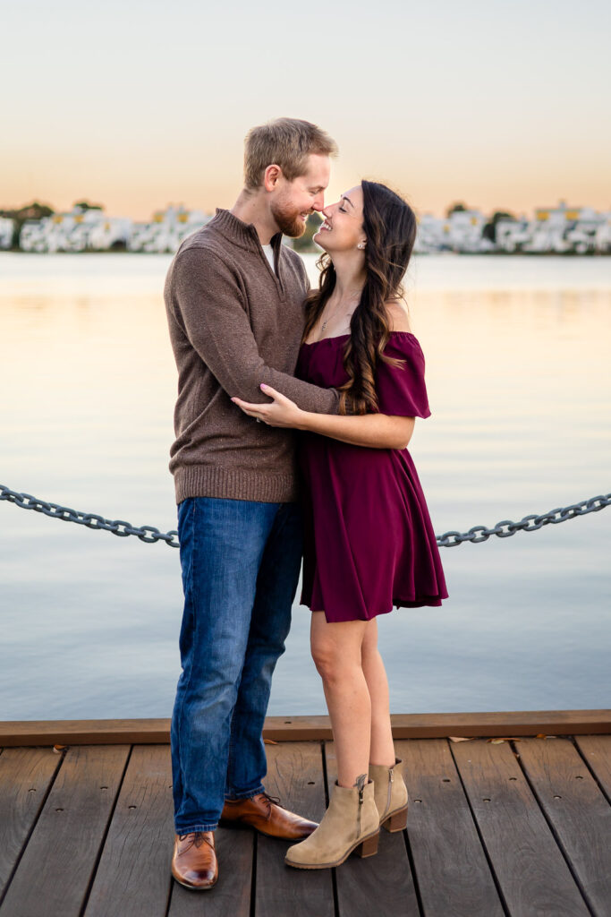 Parents embracing on a lakeside boardwalk at a San Mateo park for photoshoot essentials resource