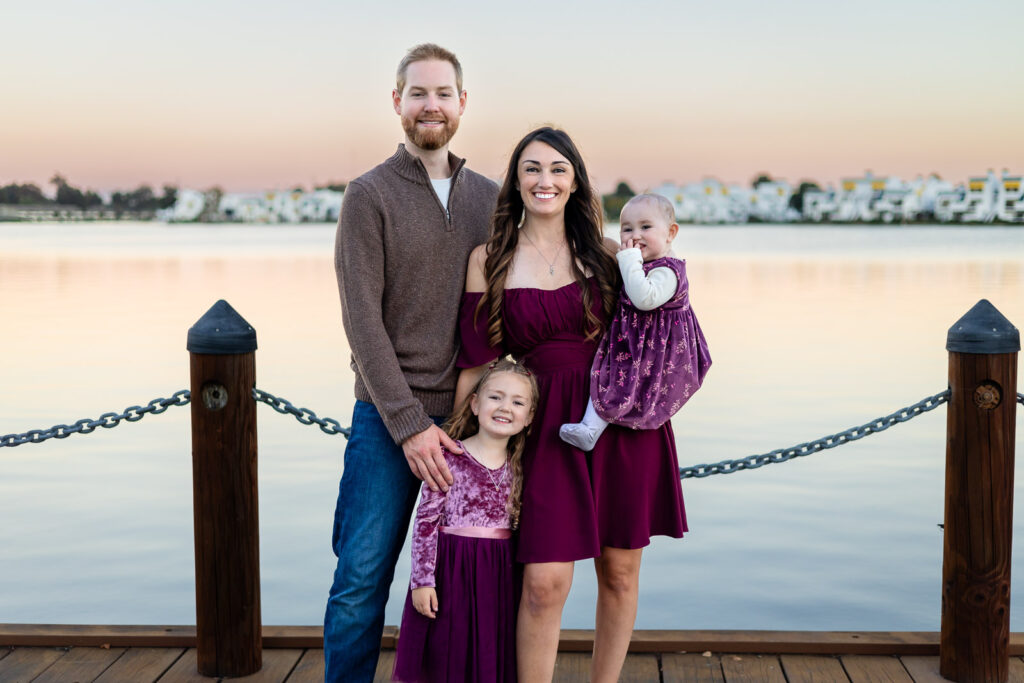 Family standing by the lake on a wooden boardwalk at a Bay Area park for a what to bring to a photoshoot article