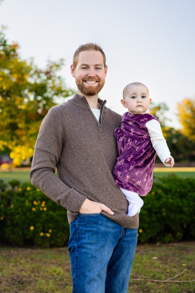Dad holding his baby at a Burlingame park for a what to bring to a photoshoot guide