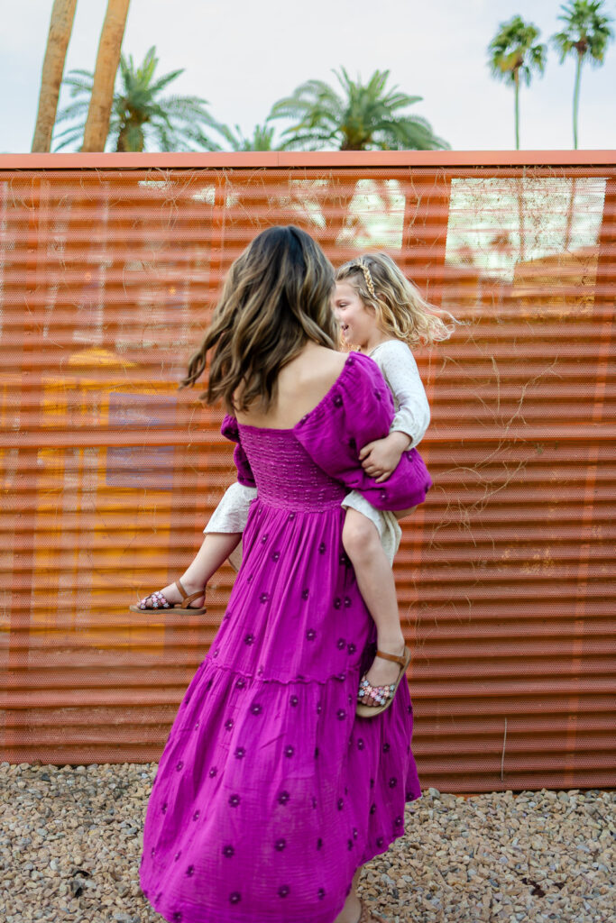 Mother holding her daughter while walking during Motherhood mini sessions Peninsula colorful outdoor lifestyle portrait