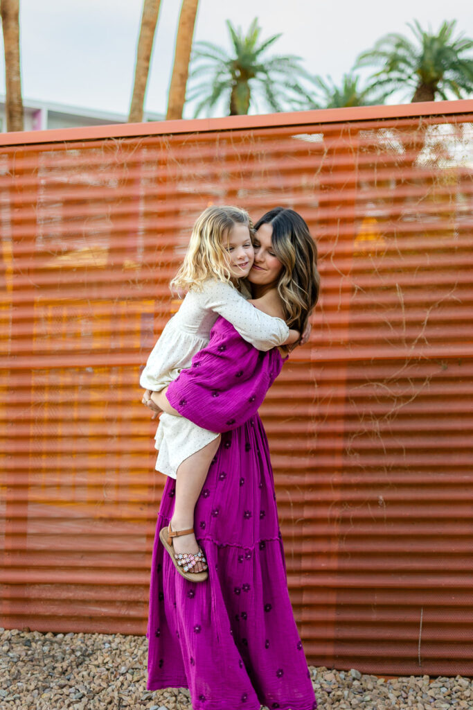Mother hugging daughter during Motherhood mini sessions Peninsula joyful outdoor motherhood portrait