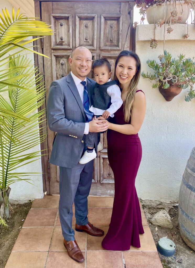 A well-dressed family posing together in front of a rustic wooden door, showcasing a connected and personality-filled family portrait.