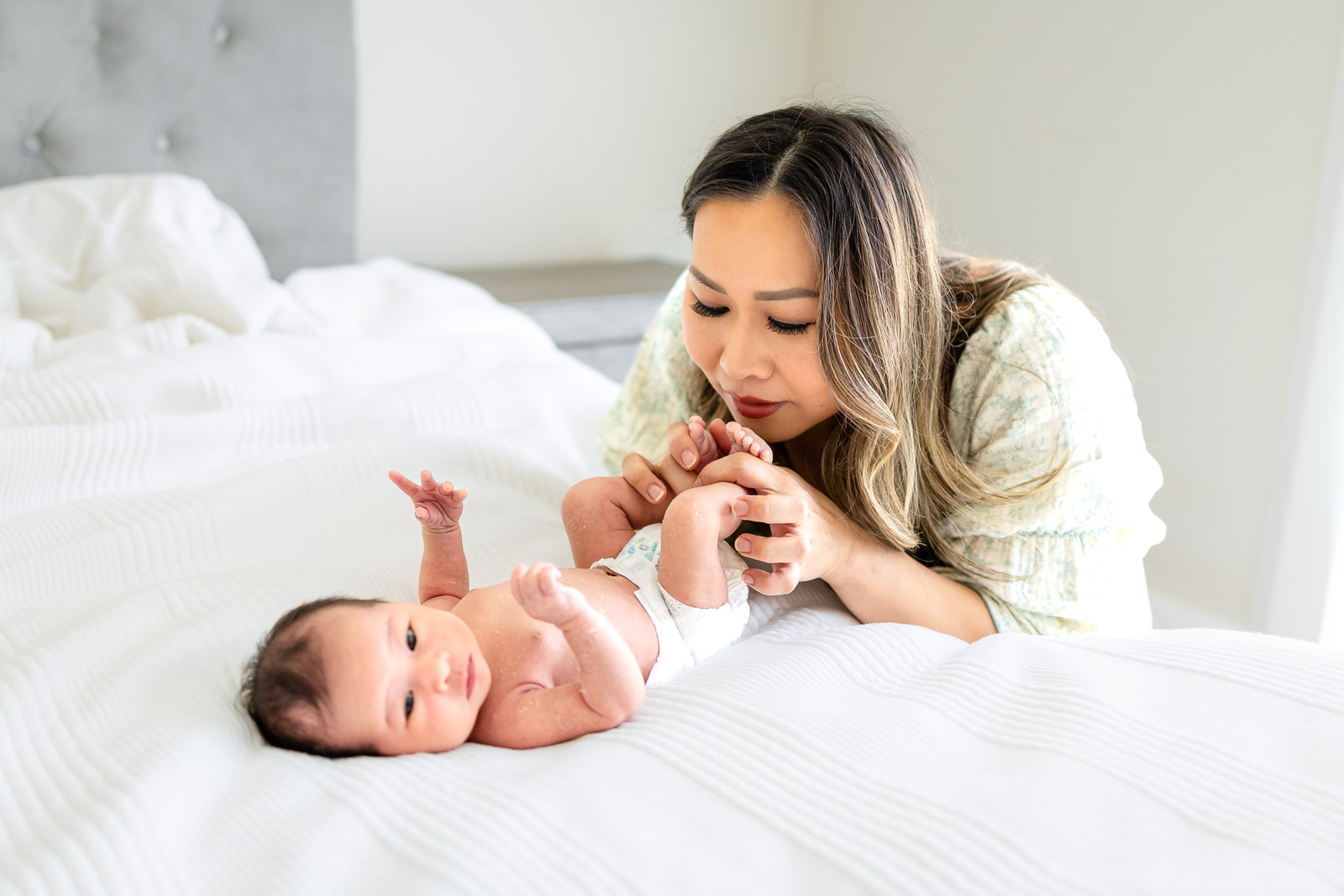 A detailed close-up of a sleeping newborn baby's face, focusing on the small, fleeting features that parents want to remember forever, taken during a calm in-home session in San Mateo County.