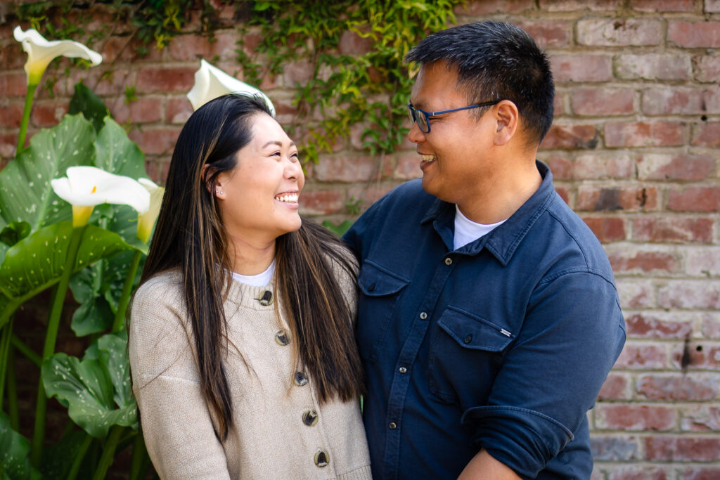 A couple sharing a quiet, emotionally present moment during a high-end garden photo session.