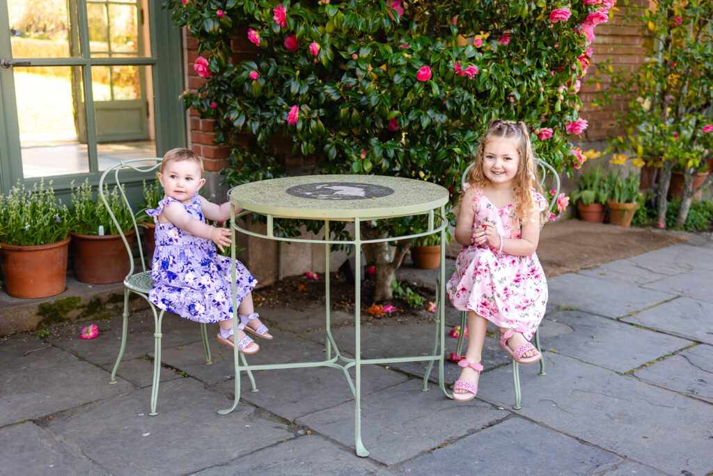 Two children sitting at a garden table at Filoli, capturing a relaxed lifestyle family photography moment.