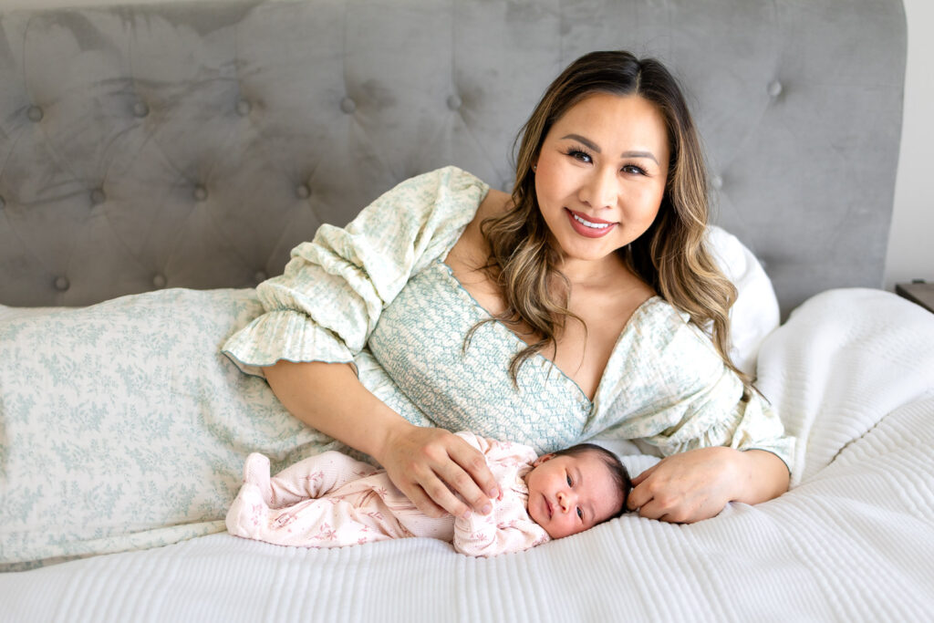 A calm and connected family holding their new baby in a bright, airy San Mateo home, highlighting a stress-free lifestyle newborn photography session.