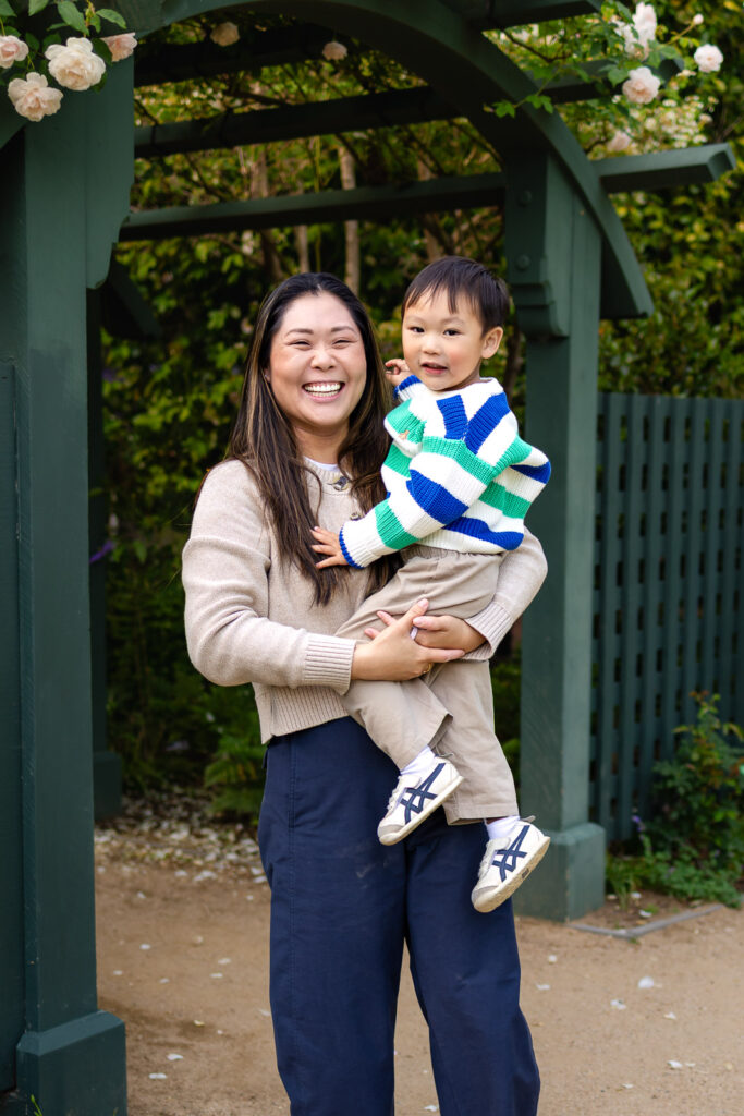 A calm, guided maternity session featuring a mother under the lavender wisteria canopy at Gamble Garden, Palo Alto.