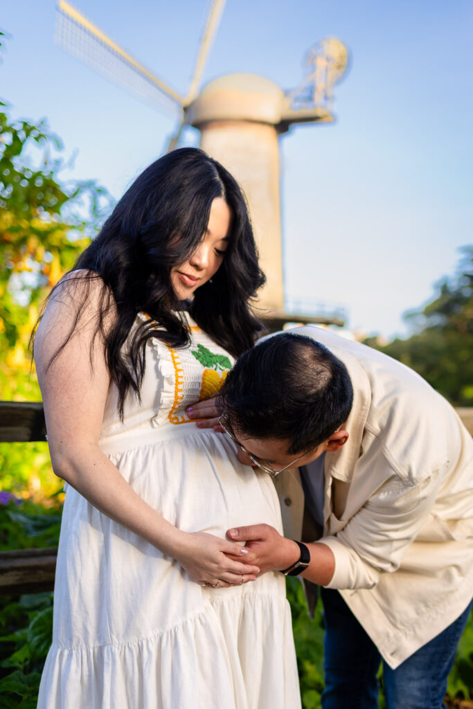 A close-up of a couple sharing a tender moment in a San Francisco flower garden, showing the relaxed and guided posing of a spring mini session.