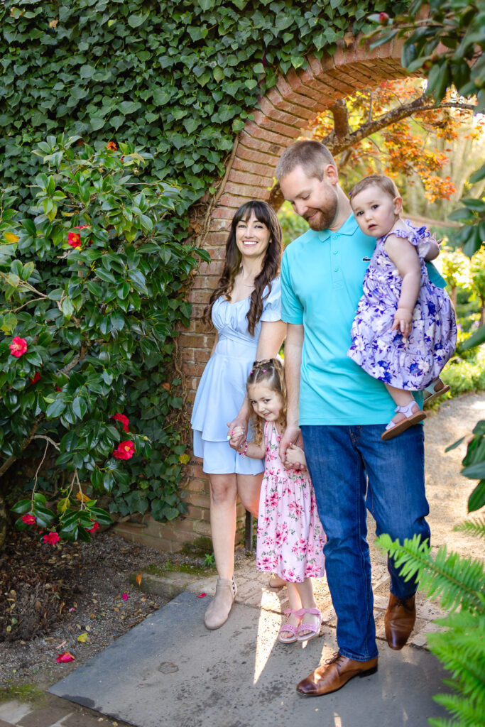 A family walks through a historic stone archway at Filoli Garden during peaceful early morning members-only hours.