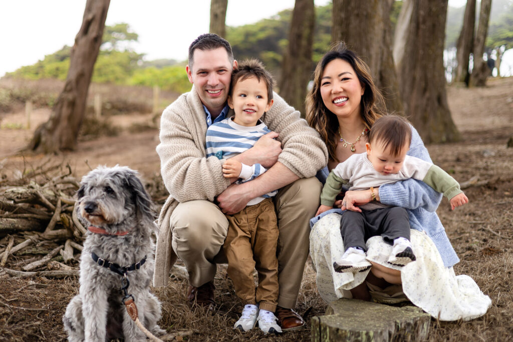 A family of four and their dog sitting together during a San Francisco family photo session.