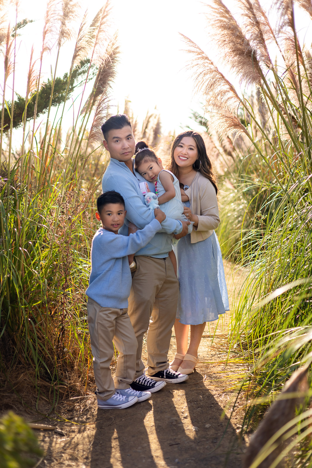 Family standing together in a golden pampas grass field near Pacifica