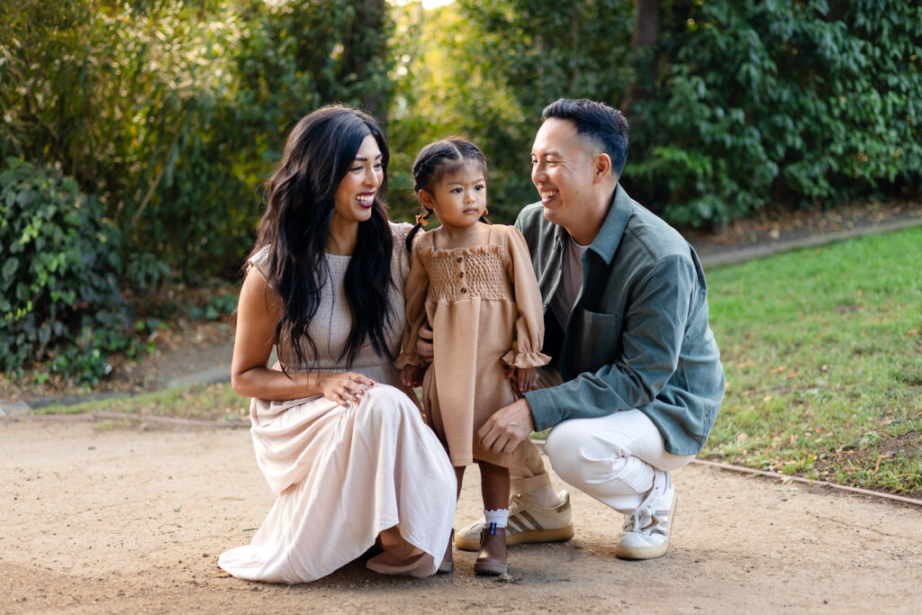 Parents smiling with their toddler during a candid family photography session