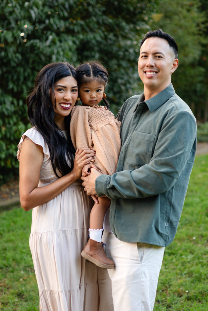 Family portrait with natural smiles and neutral outfits for holiday cards