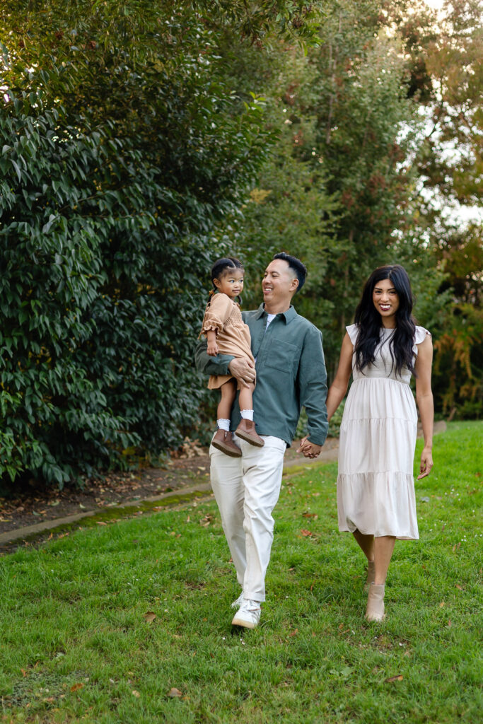 Family walking through a park during family holiday photography in San Mateo County