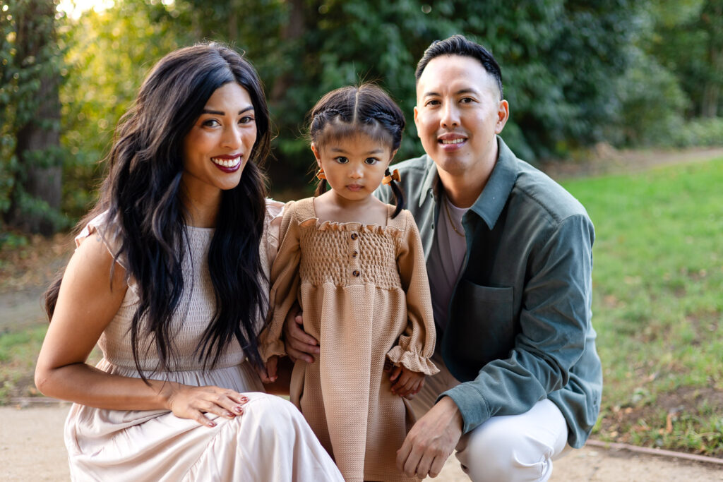 Family wearing coordinated neutral tones for an outdoor portrait session