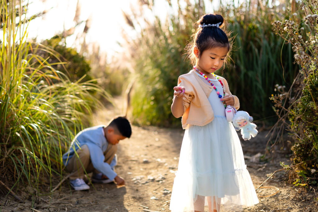Young girl exploring native plants near the pampas field