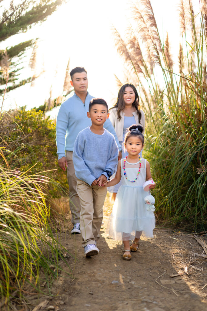 Family portrait surrounded by tall pampas grass in Pacifica Bay Area