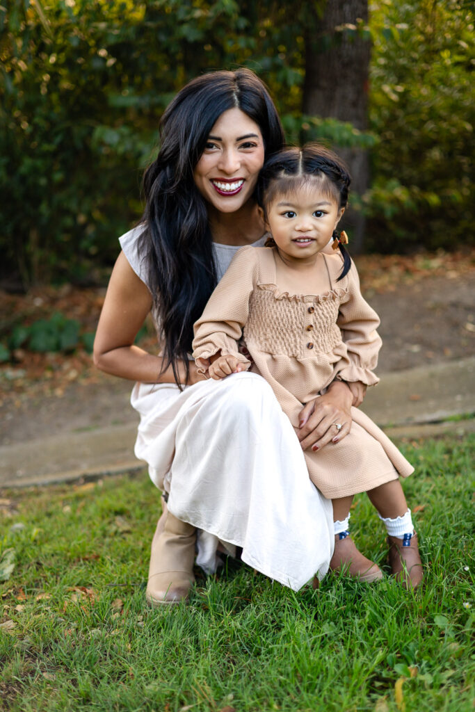 mother and young child standing in a grassy field during a family photography session