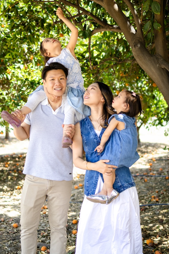 Family wearing coordinated blue, white, and neutral clothing for outdoor portraits