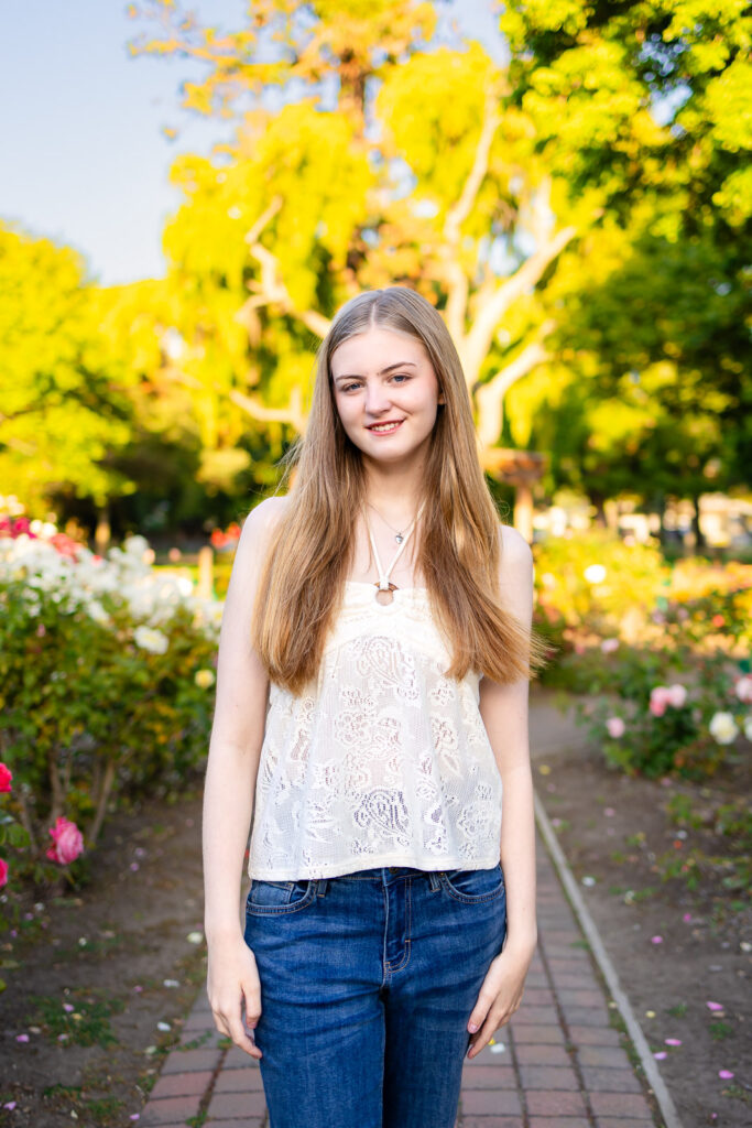 Senior wearing jeans and a white top, a timeless outfit idea for senior portraits
