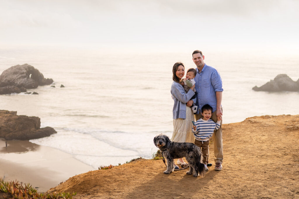 Family overlooking the San Francisco Lands End coastline with a dog