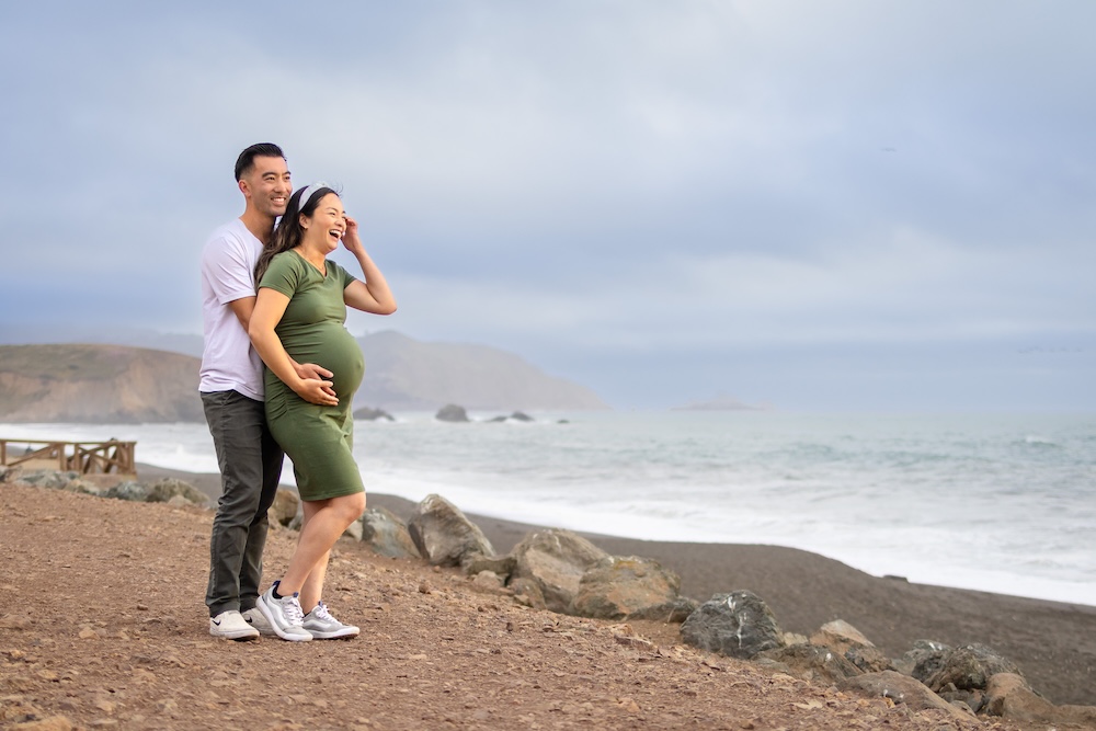 Couple enjoying a maternity session overlooking the Pacific Ocean in Pacifica.